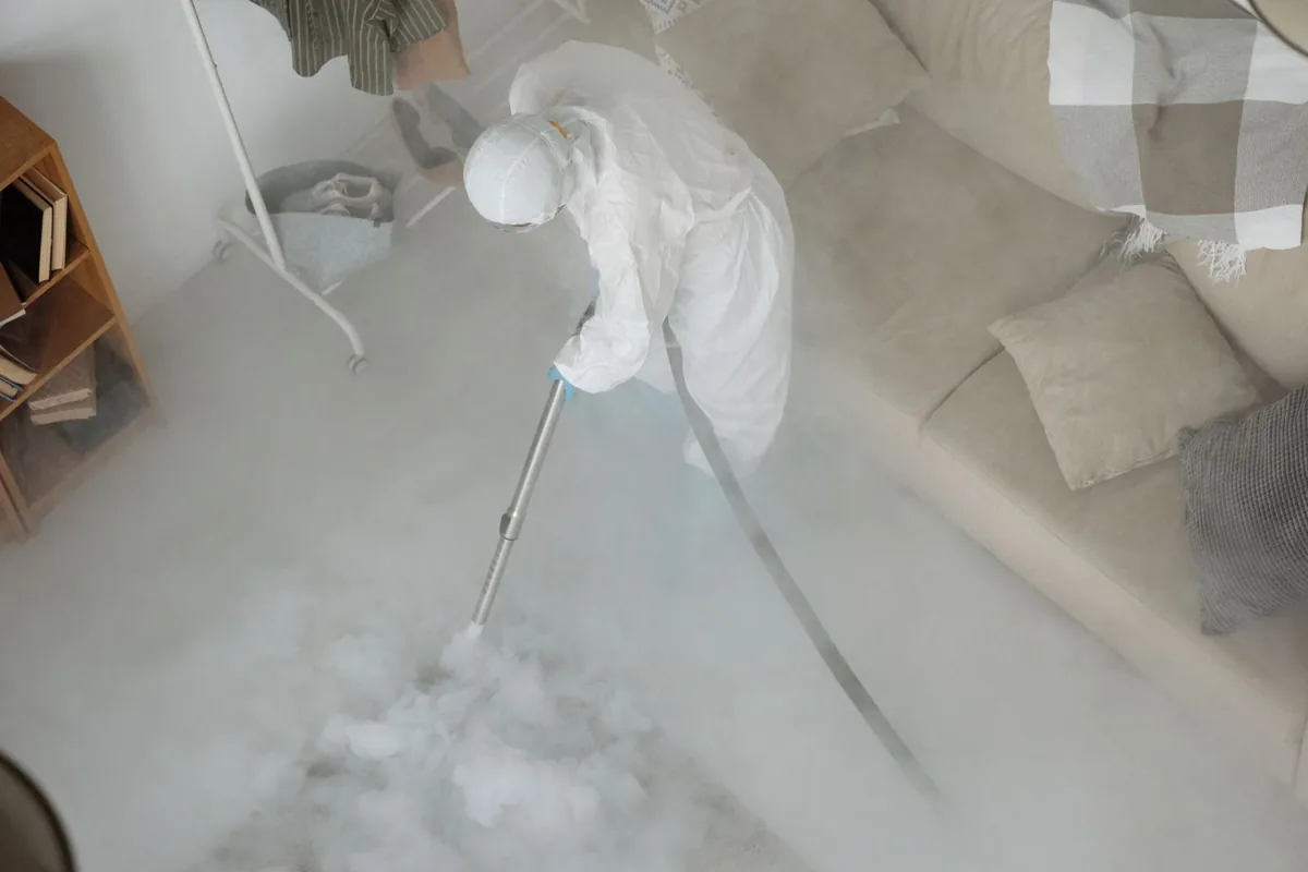 Biohazard cleanup technician in protective equipment, Green Valley Farms, TX